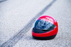 motorcycle skid marks and helmet on road