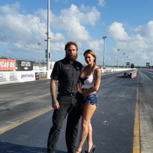 A couple standing on a race track.