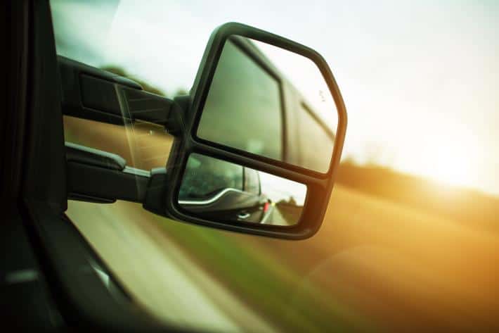 A close-up of a trucks side-view mirror.