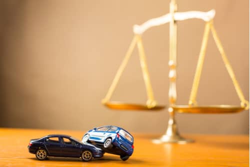 concept of Laurel car accident lawyer, scales and model cars